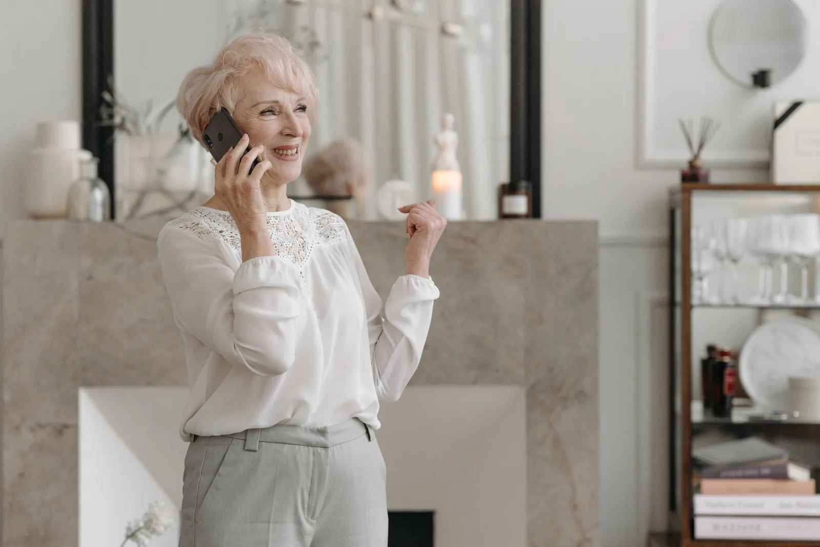 Older woman talking on a mobile phone at home