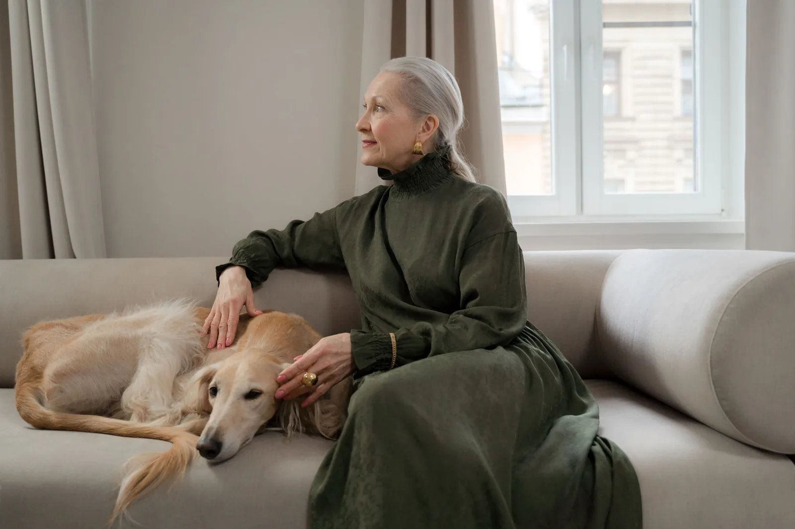 Older woman sitting with her dog on a sofa