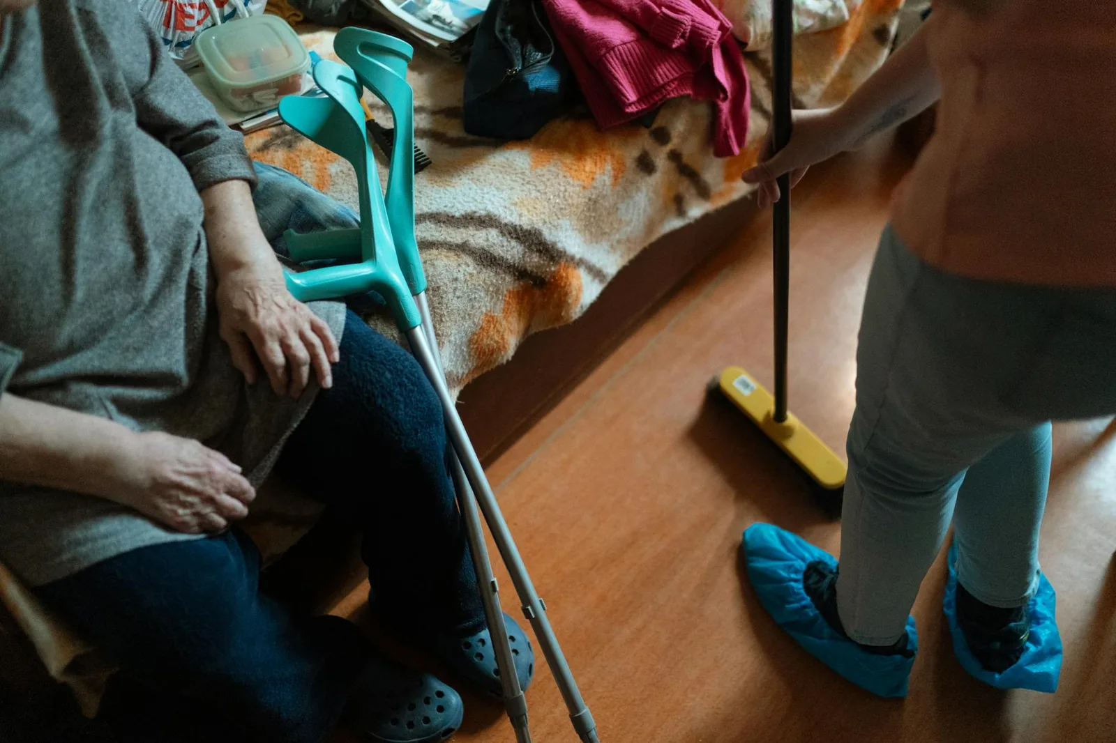 A caregiver helping an elderly woman at home.